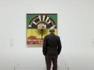 curator looking at noah purifoy work